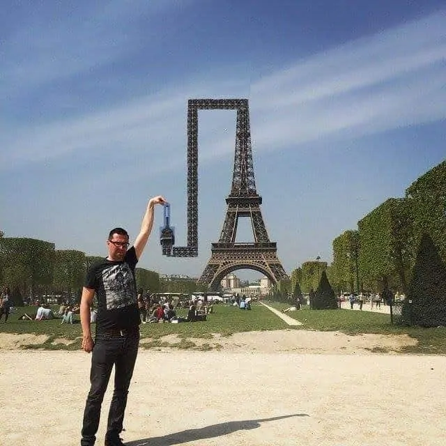 Eiffel Tower bends itself so that the finger can touch it