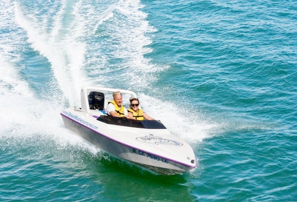 Husband rides speedboat with wife