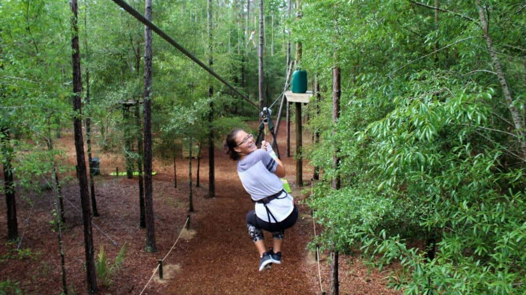 Lady on a zip line at Orlando Tree Trek