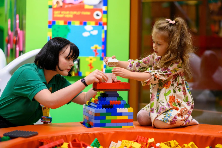 Legoland Discovery Center Manchester staff plays with child