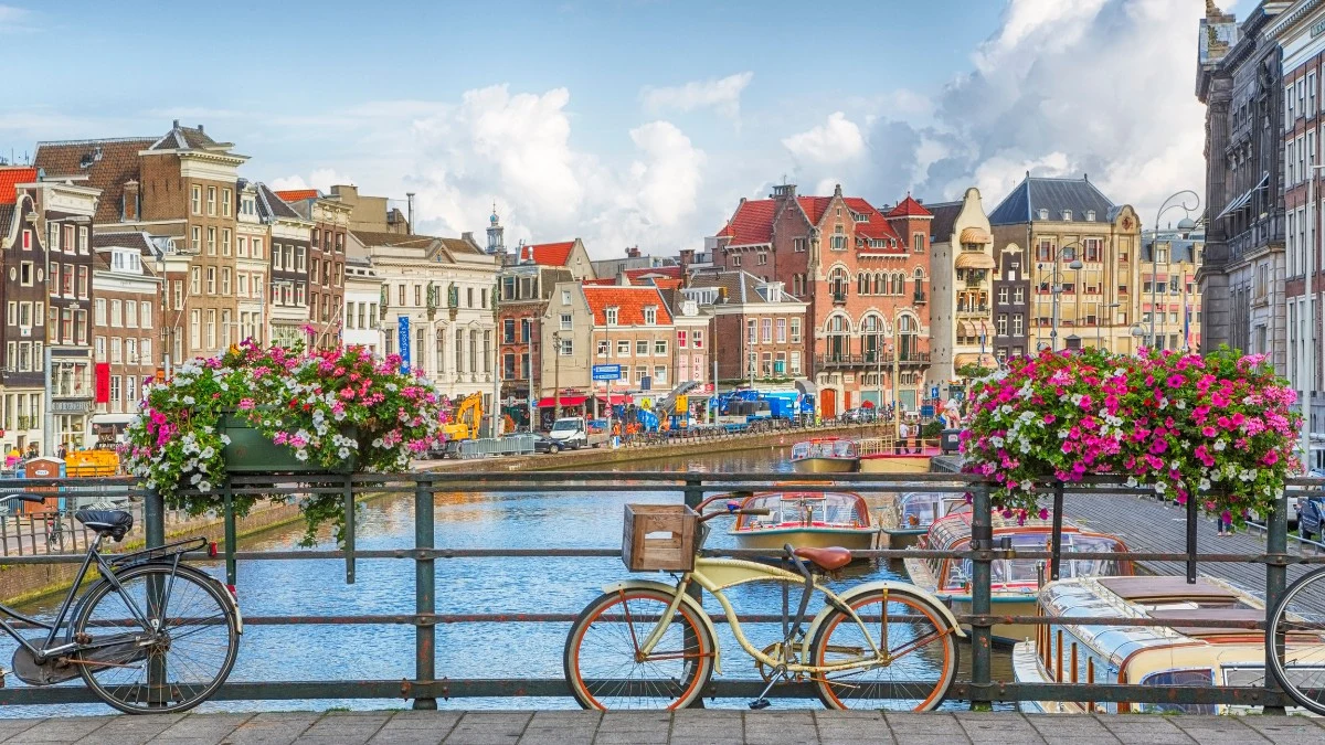 Tourists in Amsterdam leave their cycles on the bridge