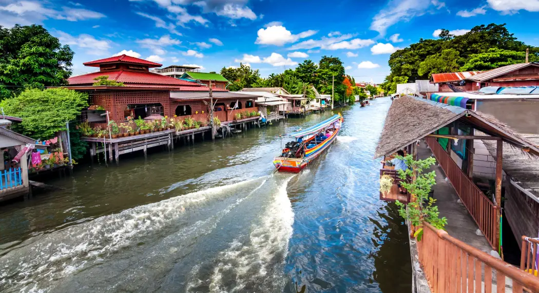 A Bangkok canal tour on the Chao Phraya River with stilt houses on both sides