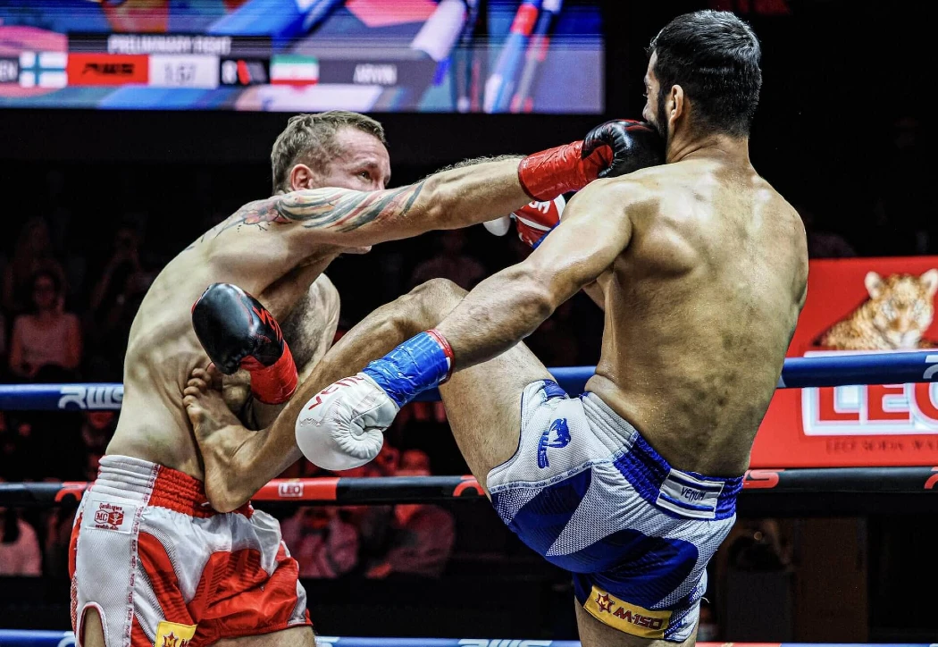 Muay Thai fighter defends a punch