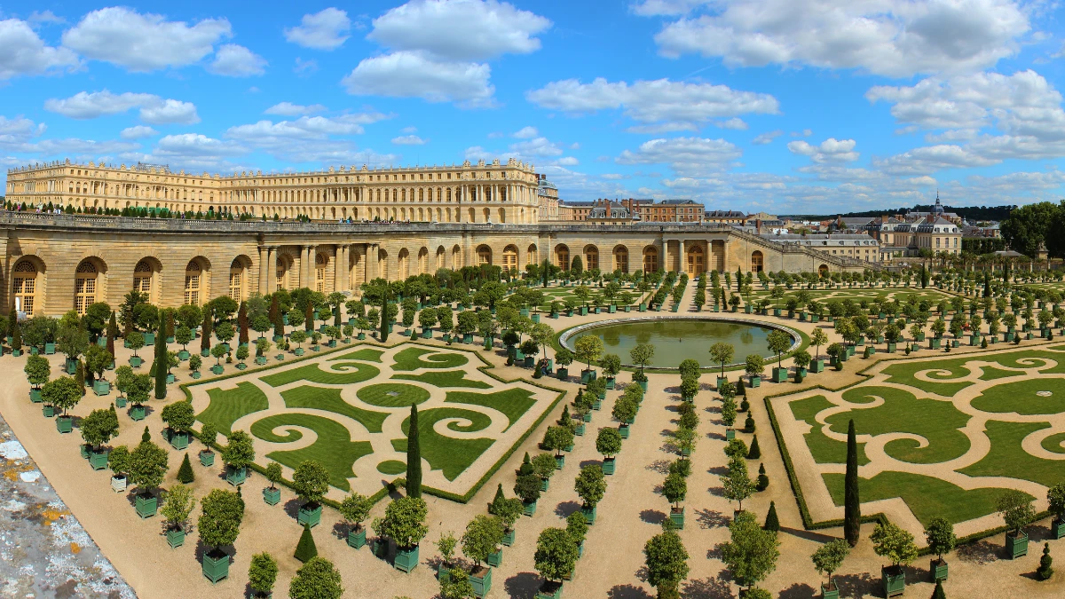 The Palace of Versailles with its beautiful gardens and clear blue sky.