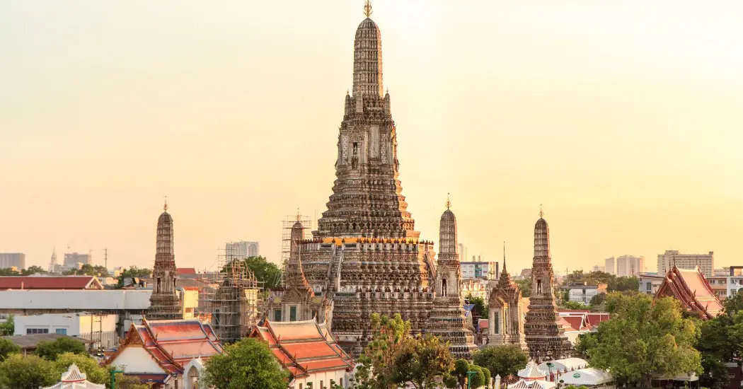 Wat Arun temple during sunset with golden light in the sky
